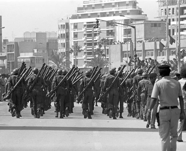Members of the Libyan Armed Forces march at a military parade in Benghazi to mark the tenth anniversary of the overthrow of the monarchy, in September 1979.