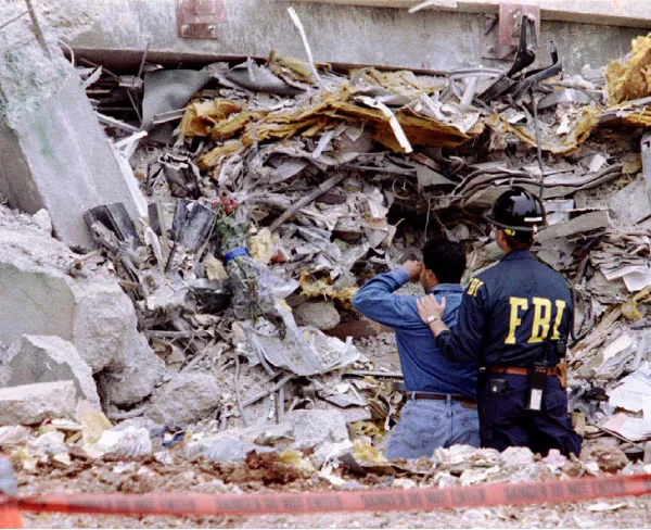 An FBI agent comforts a man at the site of the bombed Murrah Federal Building in Oklahoma City, on May 5, 1995.