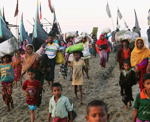 Rohingya refugees, who fled from Myanmar by boat last night, walk toward a makeshift camp in Cox's Bazar, Bangladesh, on November 9, 2017.
