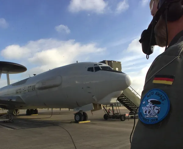 A German crew member of a NATO Airborne Warning and Control Systems (AWACS) aircraft inspects the E-3A Aircraft prior to its departure at the NATO air base in Geilenkirchen, Germany, on October 10, 2001.