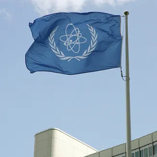 The flag of the International Atomic Energy Agency (IAEA) flies in front of the Vienna headquarters.