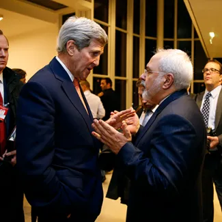 U.S. Secretary of State John Kerry talks with Iranian Foreign Minister Mohammad Javad Zarif in Vienna on January 16, 2016, after the International Atomic Energy Agency verified that Iran has met all conditions under the nuclear deal.