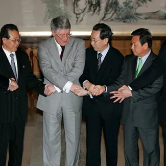 Envoys to the six party talks on North Korea's nuclear issue shake hands at the beginning of another round of the talks in Beijing on July 10, 2008.