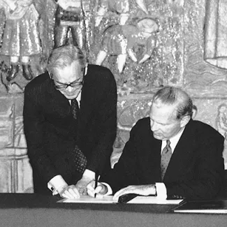 U.S. Secretary of State James Baker, right, and Russian Foreign Minister Andrei Kozyrev sign a protocol to the Strategic Arms Reduction Treaty in Lisbon on May 23, 1992.