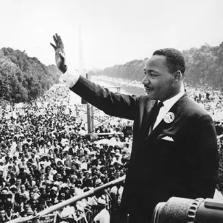 Civil rights leader Martin Luther King Jr. waves at the crowd during the March on Washington at the Lincoln Memorial in Washington, DC, where he gave his “I Have a Dream” speech, on August 28, 1963.