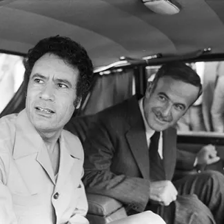 Libyan leader Muammar al-Qaddafi (left) and Syrian President Hafez al-Assad are seen in a car together during a conference of Arab leaders to oppose the Camp David Accords, in Damascus, on September 25, 1978.