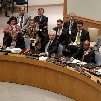 Vitaly I. Churkin (second from right), the Russian representative to the United Nations, vetoes a draft resolution on Syria at the UN headquaters in New York on February 4, 2012.