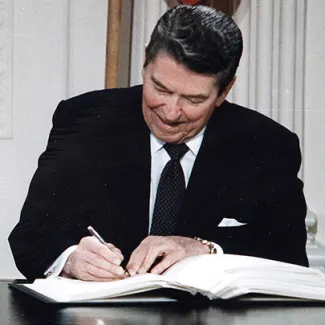 U.S. President Ronald Reagan signs the INF Treaty in the East Room of the White House on December 8, 1987.