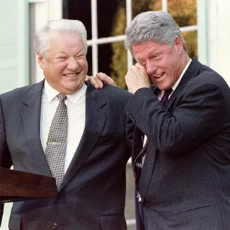 U.S. President Bill Clinton wipes away tears of laughter as he leans on Russian President Boris Yeltsin after a remark by Yeltsin during a joint press conference following their talks in Hyde Park, New York, on October 23, 1995.