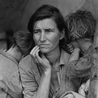 A mother with three of her children at a pea-pickers' camp in Nipomo, California in March 1936.