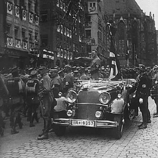 A parade of Nazi troops marches past Adolf Hitler in Nuremberg, Germany, in 1935.