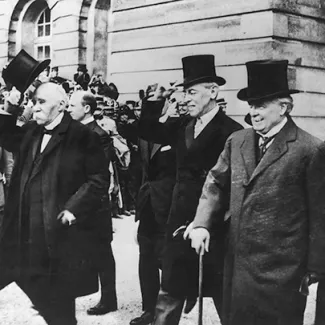 British Prime Minister David Lloyd George (right), U.S. President Woodrow Wilson (center), and French Prime Minister Georges Clemenceau attend the peace conference at the end of World War I on June 1, 1919.