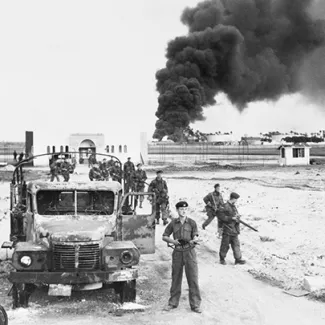 British troops invade Egypt and oil installations burn at Port Said, north of the Suez Canal, on November 10, 1956.