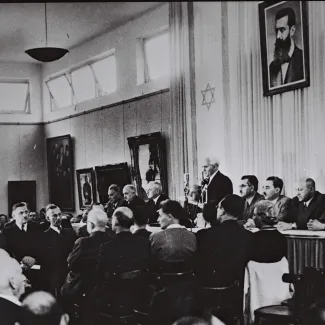 David Ben-Gurion, flanked by the members of his provisional government, reads the Declaration of Independence in the Tel Aviv Museum Hall on May 14, 1948.