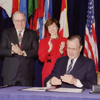 U.S. President George Bush caps his pen after signing the North American Free Trade Agreement at the Organization of American States headquarters on December 17, 1992, in Washington D.C.