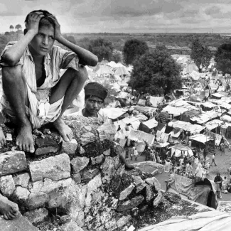 A distraught boy sat on the walls of a refugee camp in Delhi during the Partition of India in 1947.