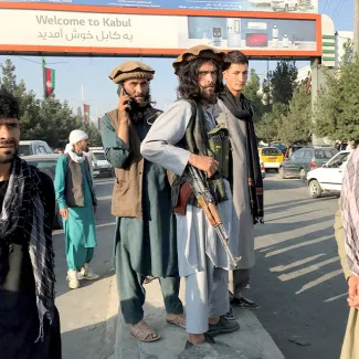 A member of Taliban (C) stands outside Hamid Karzai International Airport in Kabul, Afghanistan on August 16, 2021.