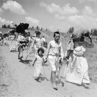 Palestinian women and children hike toward Arab-controlled territory in the West Bank on June 26, 1948.