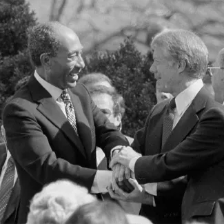 U.S. President Jimmy Carter shakes hands with Egyptian President Anwar Sadat at the signing of the Egyptian-Israeli Peace Treaty at the White House seven months after the Camp David Accords.