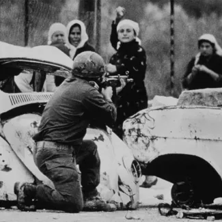 An Israeli soldier takes aim as a Palestinian woman hurls a rock at him from close range on February 29, 1988 at a demonstration following the outbreak of the intifada months earlier.