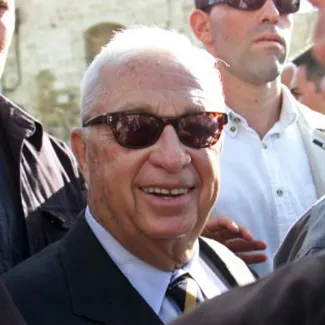 Israeli right-wing political leader, Ariel Sharon smiles after making a controversial visit to the Temple Mount (known to Muslims as al-Haram al-Sharif, one of Islam's holiest sites) on September 28, 2000.