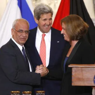Chief Palestinian negotiator Saeb Erekat, U.S. Secretary of State John Kerry, and Israel's Justice Minister Tzipi Livni shake hands at the end of negotiations in Washington DC, on July 30, 2013.