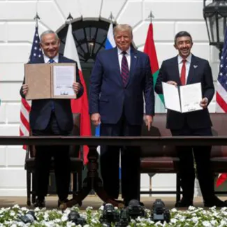 Netanyahu and United Arab Emirates Foreign Minister Abdullah bin Zayed display their copies of signed agreements while Trump looks on as they participate in the signing ceremony of the Abraham Accords at the White House on September 15, 2020.